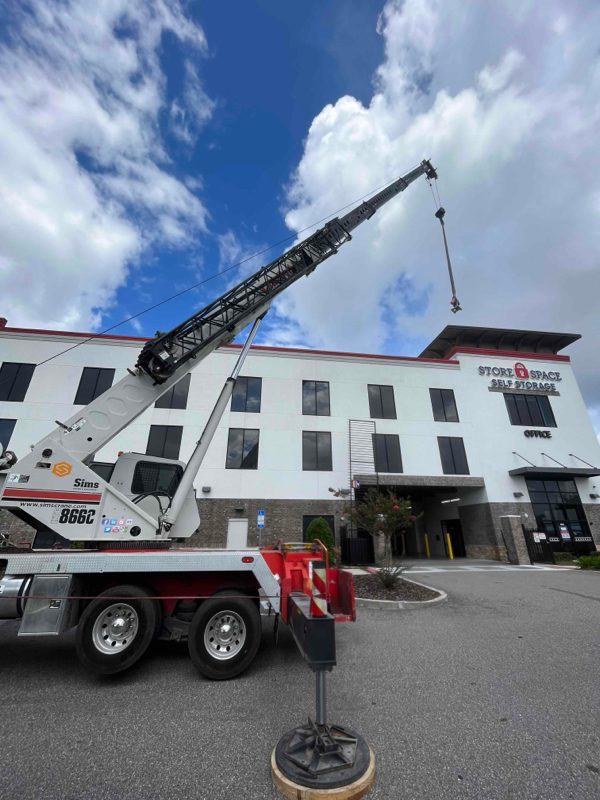 A crane staged to hoist HVAC equipment onto the roof of a Store Space Self Storage facility in Florida for SBS-NC